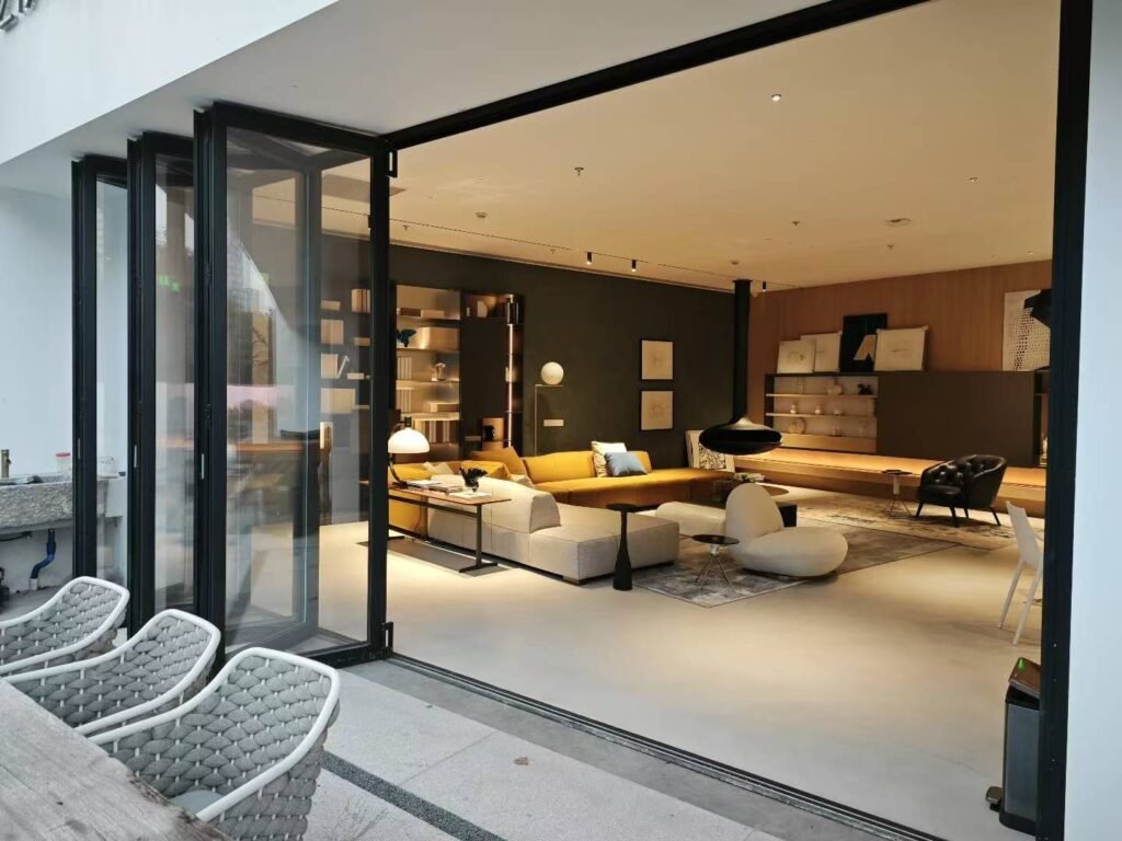 Open bi-fold glass doors connecting a living room to the patio