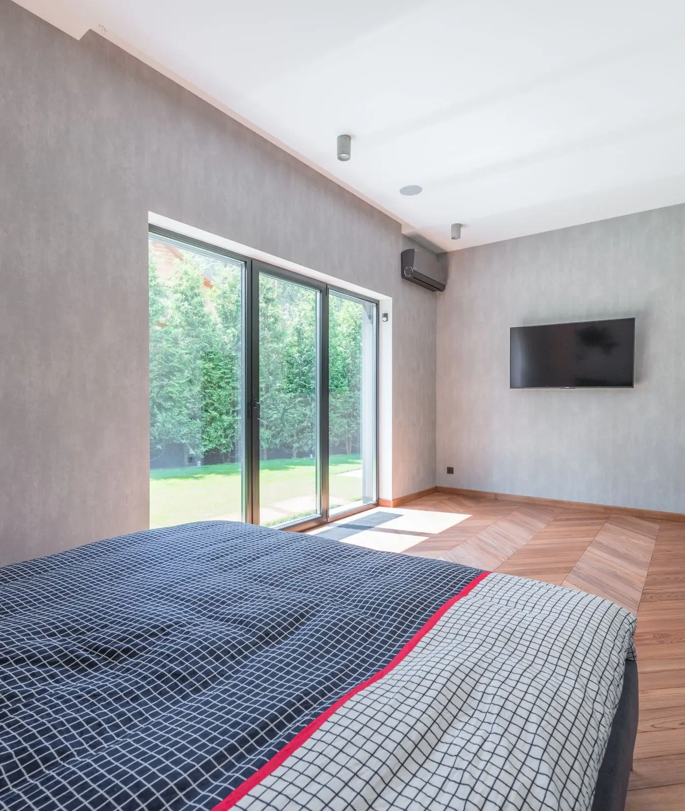 Room with glass doors opening to the garden, suited to the large wooded lots in Franklin, Michigan