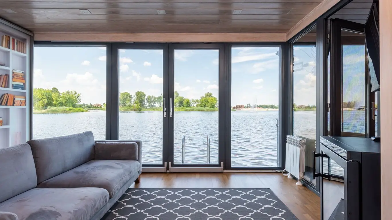 Large picture windows with a view of water and trees, popular in Rochester Hills homes